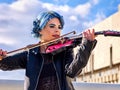 Woman perform music on violin park outdoor. Girl performing jazz. Royalty Free Stock Photo