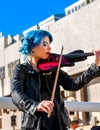 Woman perform music on violin park outdoor. Girl performing jazz .