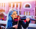 Woman perform music on violin park outdoor. Girl performing jazz . Royalty Free Stock Photo