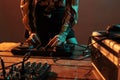 Woman performer mixing techno music on turntables
