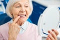 Woman performing a check of her loose tooth Royalty Free Stock Photo