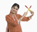 Woman performing Dandiya Raas on Navratri
