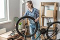 Woman is performing maintenance on his mountain bike. Concept of fixing and preparing the bicycle for the new season