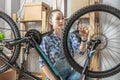 Woman is performing maintenance on his mountain bike. Concept of fixing and preparing the bicycle for the new season