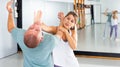 Woman performing palm heel strike while training in gym Royalty Free Stock Photo