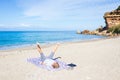Woman performing yoga exercises on a beautiful empty beach in Greece. Dramatic coastline scenic bay rocky cliffs in the Ionian Royalty Free Stock Photo