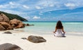 Woman performing yoga on a tropical beach