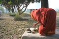 Woman performs traditional morning worship ritual in courtyard