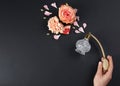 Woman with perfume. Fragrance composition, flowers and grapefruit on black background. Space for text