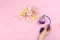 Woman with perfume. Fragrance composition, flowers and lemon on pink background Royalty Free Stock Photo