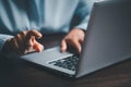 Woman person hands with laptop computer on wooden table for business or technology background