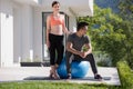 Woman and personal trainer doing exercise with pilates ball Royalty Free Stock Photo