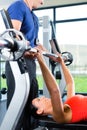 Woman and Personal Trainer in gym Royalty Free Stock Photo