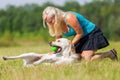 Woman pets a labrador at the belly