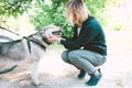 A woman pets a Laika dog