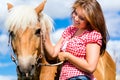 Woman petting horse on farm Royalty Free Stock Photo