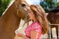 Woman petting horse on pony farm Royalty Free Stock Photo