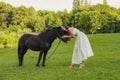 woman petting a pony Royalty Free Stock Photo