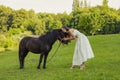 woman petting a pony Royalty Free Stock Photo