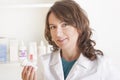 Woman pharmacist with a bottle of drugs