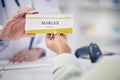 Woman, pharmacist and hands with box of pills for medication, cure or prescription on counter at pharmacy. Closeup of Royalty Free Stock Photo