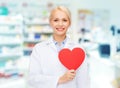 Woman pharmacist with heart at drugstore