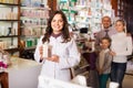 Woman pharmacist helping customers