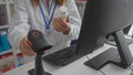 A woman pharmacist scans a medication bottle at the pharmacy counter indoors using a barcode scanner Royalty Free Stock Photo