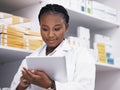 Woman, pharmacist or tablet, online checklist and checking stock of medicine on shelf. African female medical Royalty Free Stock Photo