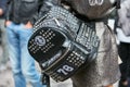 Woman with Philipp Plein black leather backpack with studs before Fay fashion show, Milan Fashion Week