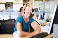 Woman On Phone In Busy Modern Office