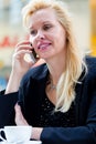 Woman with phone in cafe drinking coffee Royalty Free Stock Photo