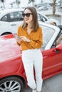 Woman with phone at the car parking Royalty Free Stock Photo