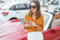 Woman with phone at the car parking Royalty Free Stock Photo