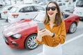 Woman with phone at the car parking Royalty Free Stock Photo