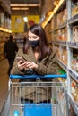 woman with phone checking shopping list app in grocery store Royalty Free Stock Photo