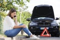 woman on phone after having made road triangle