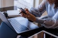 Woman using mobile phone, work on computer. Royalty Free Stock Photo