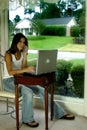 Woman on phone with laptop