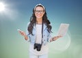 Woman with phone and laptop against blue green background with flare Royalty Free Stock Photo