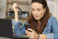 woman with phone and laptop at table Royalty Free Stock Photo