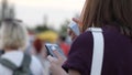 Woman with phone at outdoors, young girl communicat in social networks on party, female with mobile phone in hands