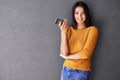 Woman, phone and wall background for mockup, smile and portrait in fashion for social media. Technology, digital and