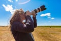 Woman photographer aiming the sky Royalty Free Stock Photo