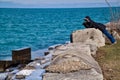 Woman photographer capturing waves splashing from Lake Michigan