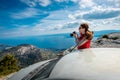 Woman photographer with car on the top of mountain Royalty Free Stock Photo