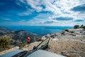 Woman photographer with car on the top of mountain Royalty Free Stock Photo