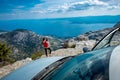Woman photographer with car on the top of mountain Royalty Free Stock Photo
