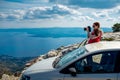 Woman photographer with car on the top of mountain Royalty Free Stock Photo