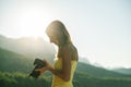 Woman photographer checking photo on camera display